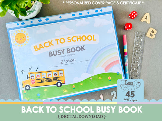 Back to school busy book with colorful cover featuring a school bus and rainbow, surrounded by educational items on a gray surface.